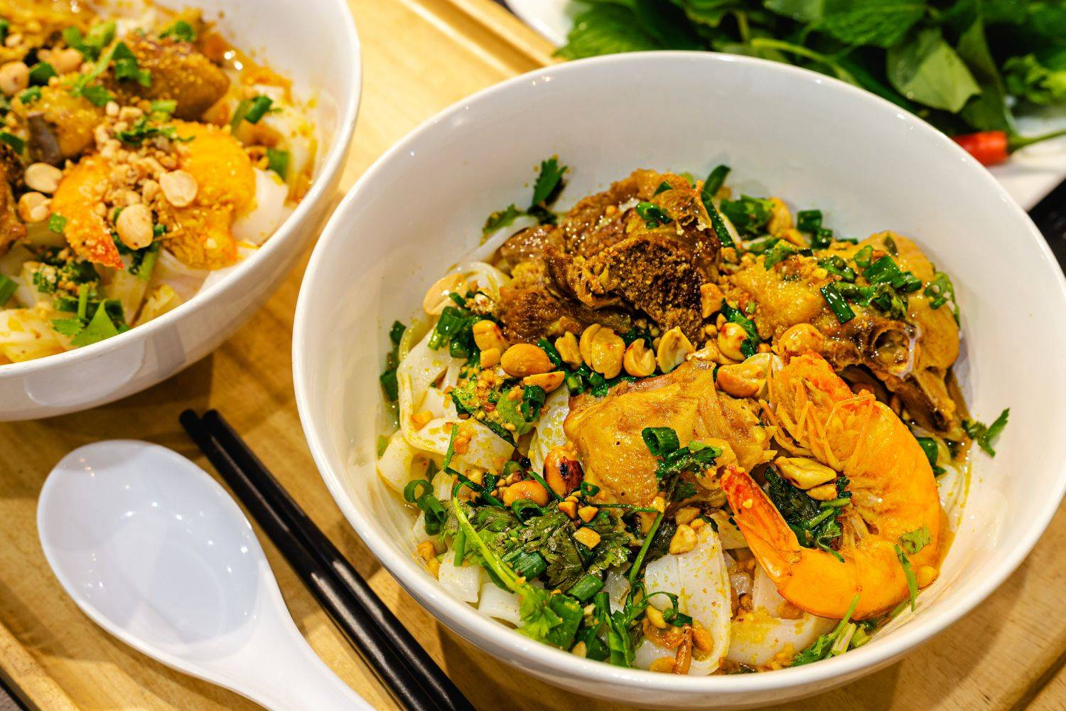 Mi Quang, a signature dish of the region, is an essential experience in any Da Nang travel guide