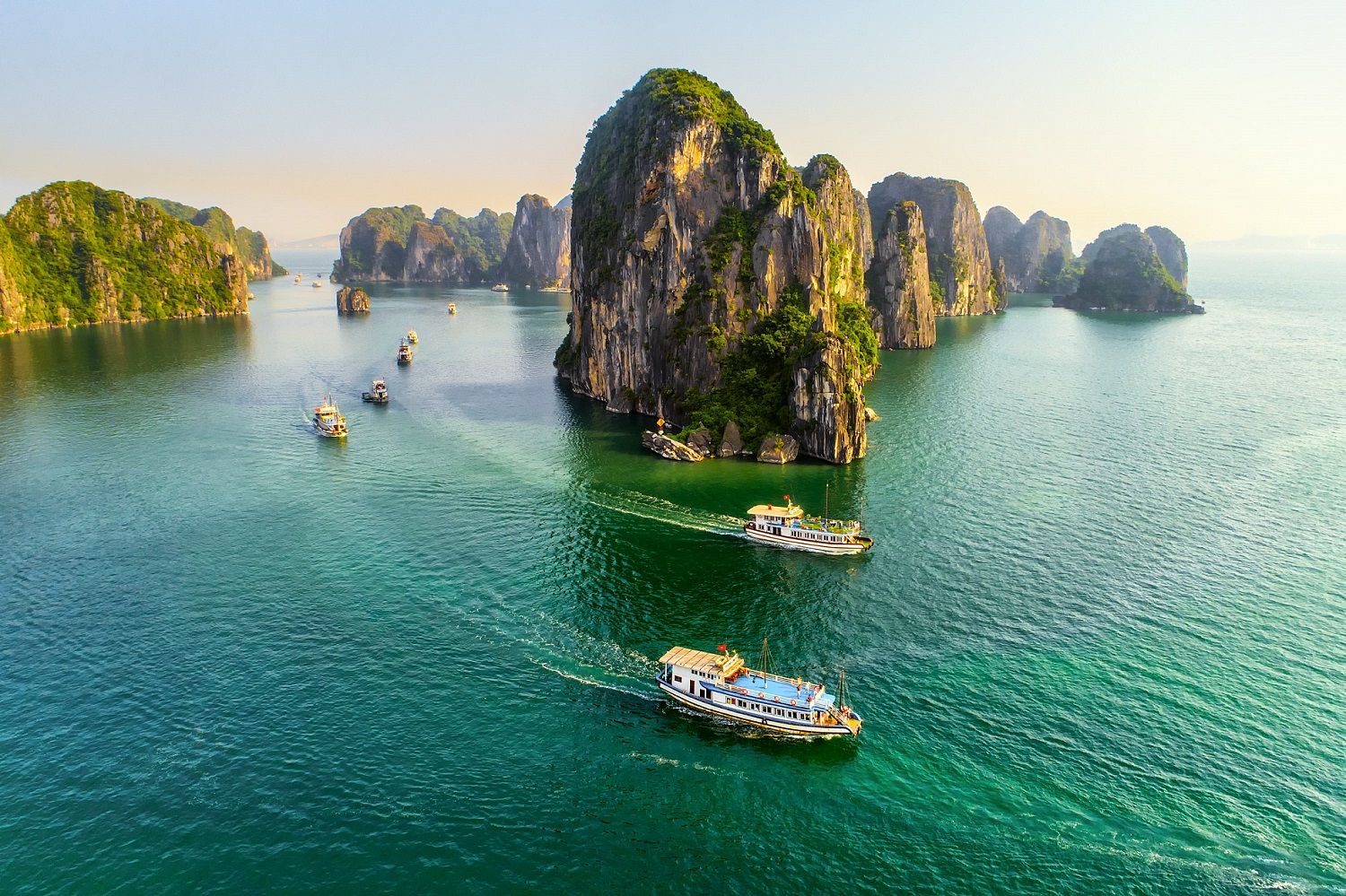 Panoramic view of Ha Long Bay’s emerald waters dotted with limestone karsts