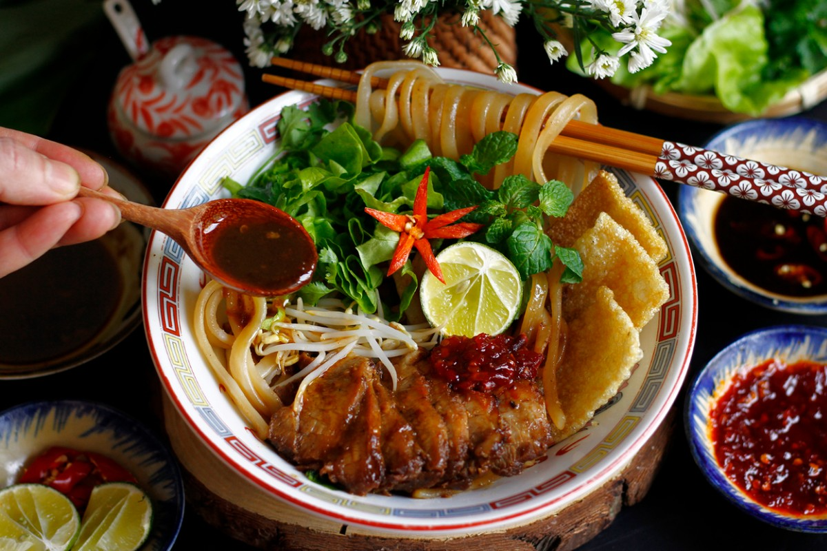 Hoi An's signature cao lau noodles and other local specialties showcase the town's culinary heritage