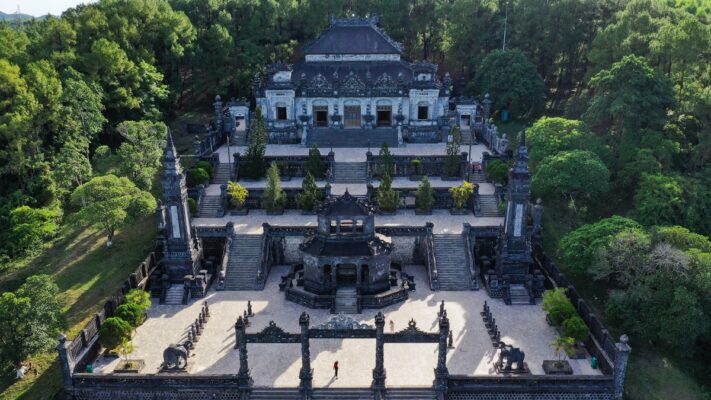 Visitors stroll through tree-lined paths leading to Minh Mang Tomb.