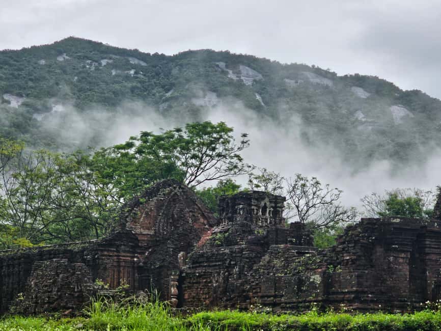 Morning mist shrouds My Son’s ruins during the rainy season, adding mystery to the scene.