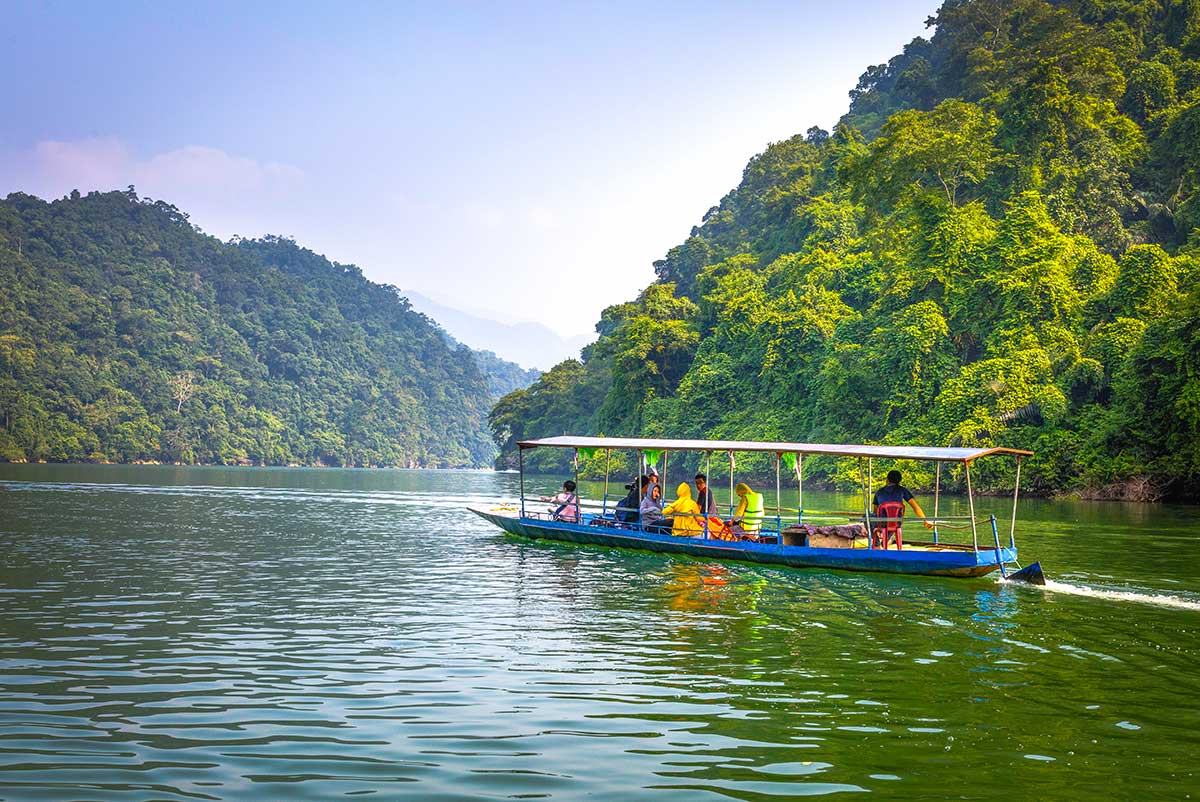 Misty Ba Be Lake ringed by limestone mountains