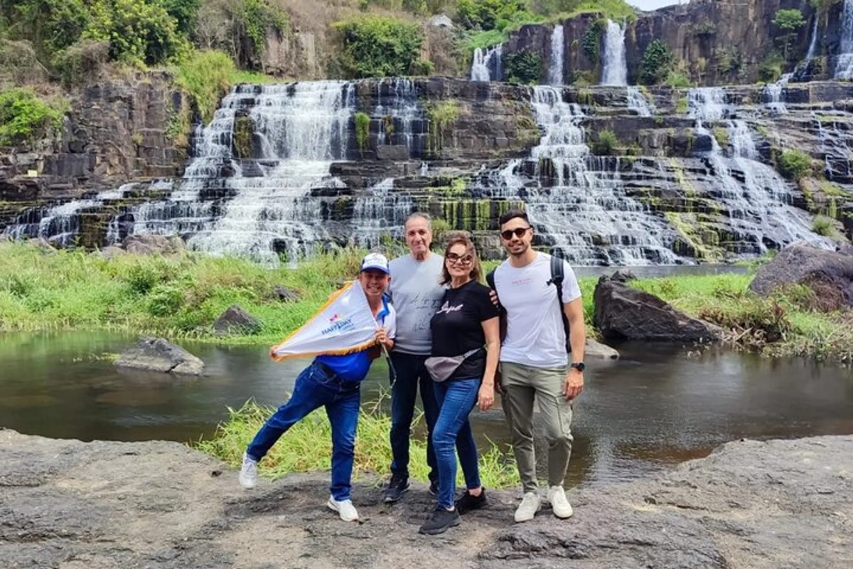 Visitors walking along the basalt steps of Pongour during the dry season.