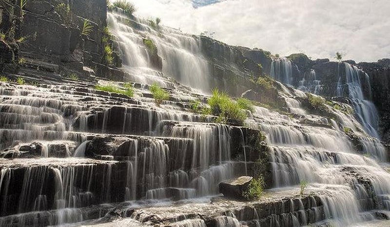 The broad, tiered expanse of Pongour Waterfall in full flow.