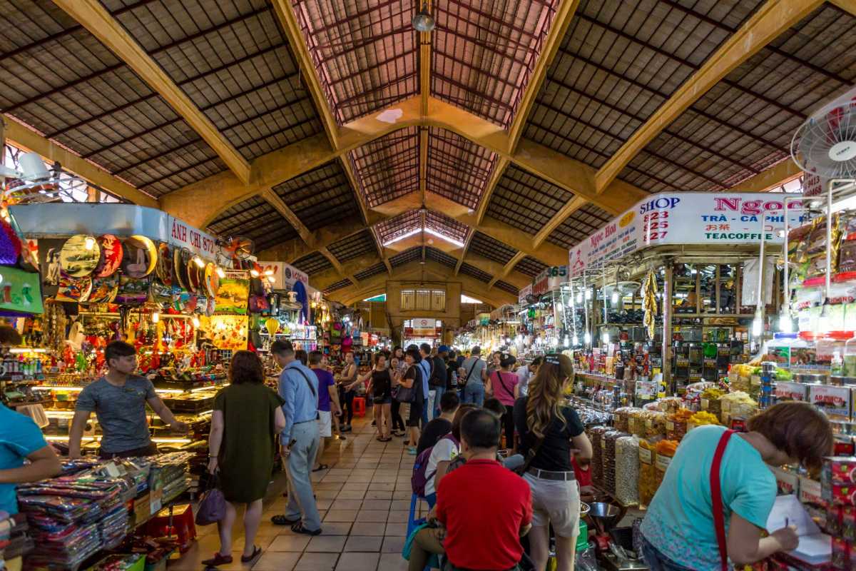 The bustling Ben Thanh night market teems with food, souvenirs, and street performances.