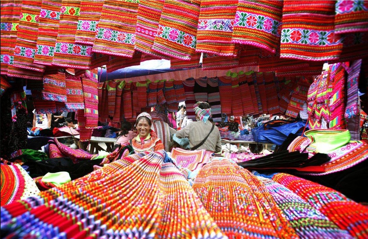 Colorful brocade and herbs at a highland market near the waterfall.