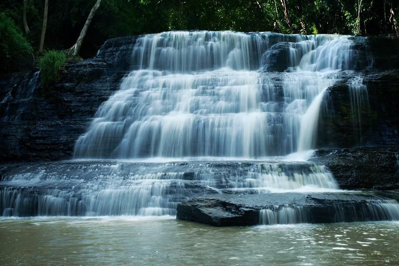 Thuy Tien Waterfall’s three gentle tiers surrounded by greenery.
