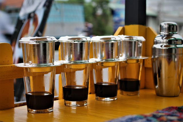 A traditional Vietnamese coffee set with a phin filter, alongside fragrant, locally grown tea.